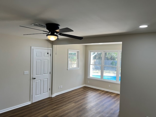 spare room featuring ceiling fan and dark wood-type flooring