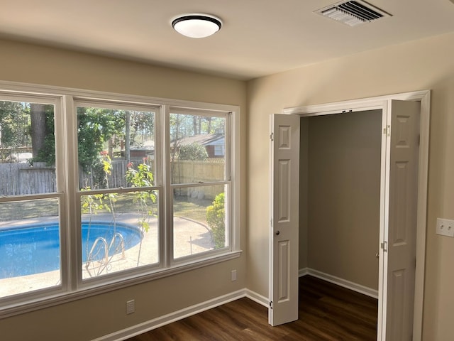 entryway featuring plenty of natural light and dark hardwood / wood-style flooring