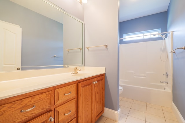 full bathroom featuring toilet, vanity, baseboards, tile patterned floors, and washtub / shower combination