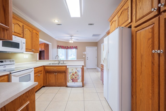 kitchen featuring white appliances, light tile patterned floors, visible vents, a peninsula, and a sink