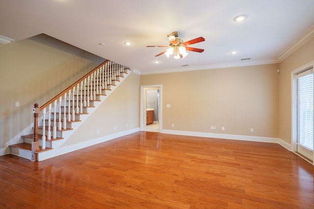 interior space with light wood-type flooring, baseboards, stairway, and crown molding