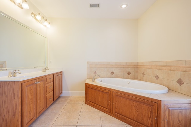 bathroom featuring a garden tub, double vanity, visible vents, a sink, and tile patterned floors