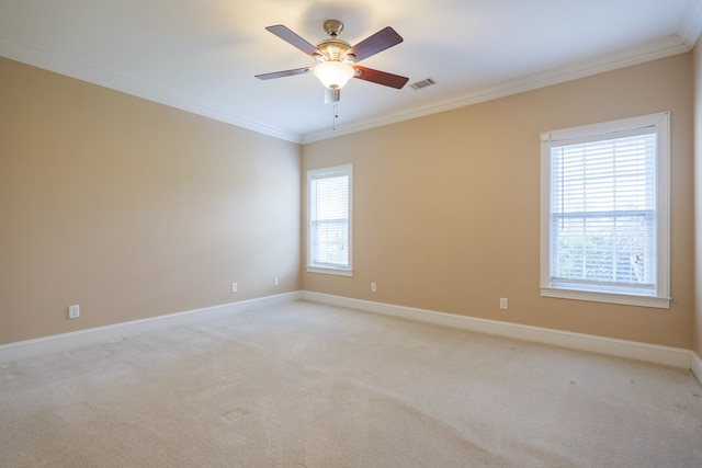 unfurnished room with baseboards, ornamental molding, visible vents, and light colored carpet