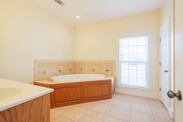 bathroom with vanity, a garden tub, visible vents, and tile patterned floors