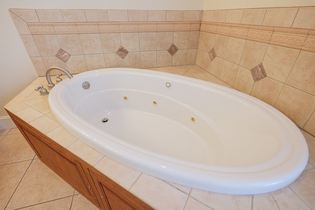 bathroom featuring a jetted tub and tile patterned flooring