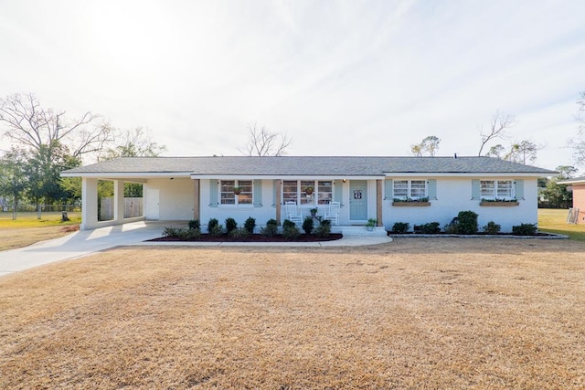 ranch-style house with a front lawn and a carport