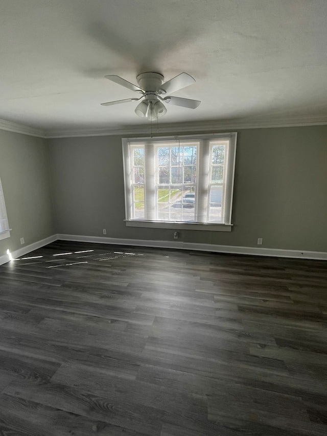 spare room featuring dark hardwood / wood-style flooring, ceiling fan, and ornamental molding