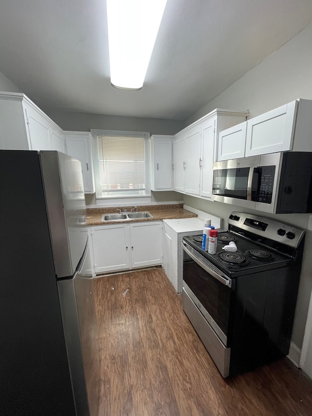 kitchen with white cabinetry, sink, appliances with stainless steel finishes, and dark wood-type flooring