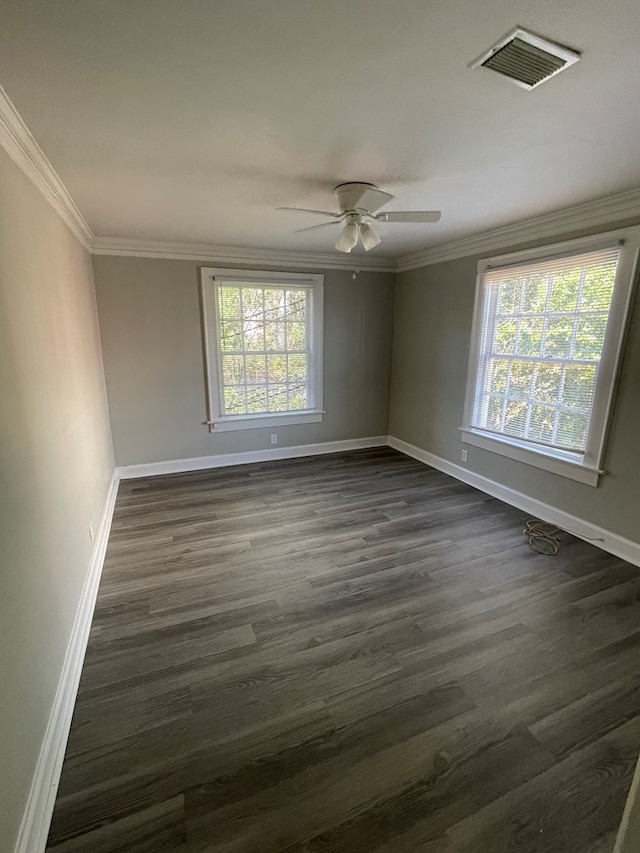 unfurnished room with ceiling fan, a healthy amount of sunlight, dark hardwood / wood-style flooring, and ornamental molding