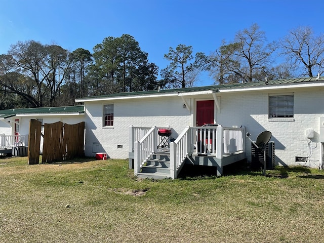 rear view of property with a lawn and central AC unit