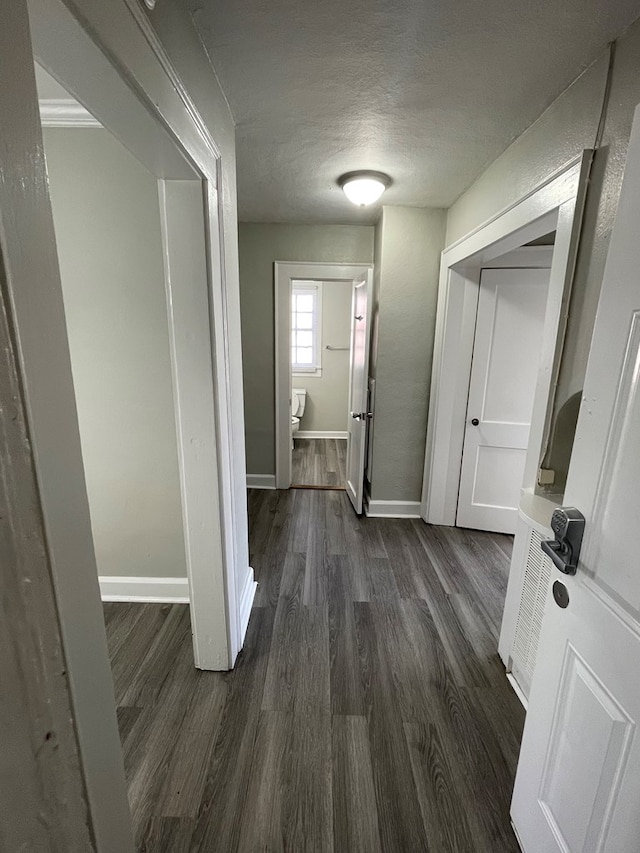 corridor featuring dark wood-type flooring