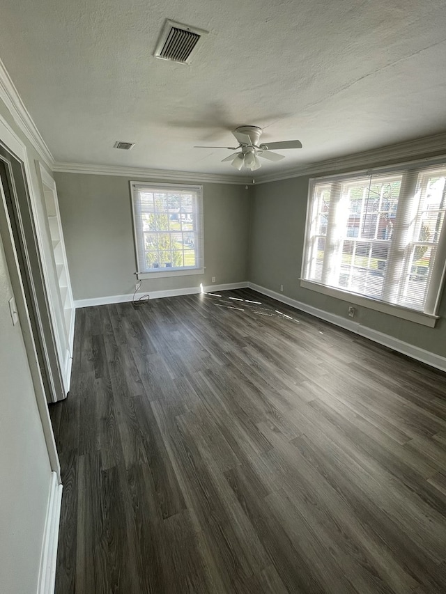 unfurnished room with ceiling fan, dark hardwood / wood-style flooring, a textured ceiling, and ornamental molding