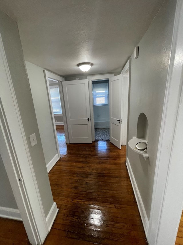 hallway featuring dark wood-type flooring