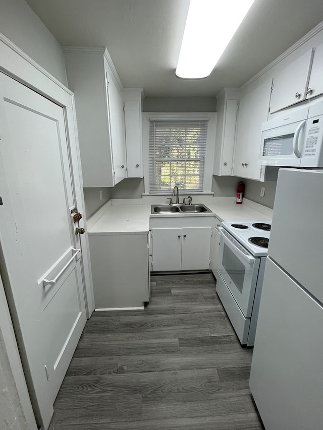 kitchen with white cabinetry, sink, dark hardwood / wood-style floors, and white appliances