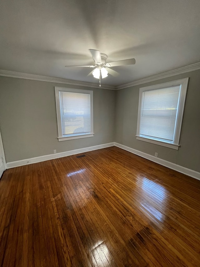 empty room featuring hardwood / wood-style floors, ceiling fan, and crown molding