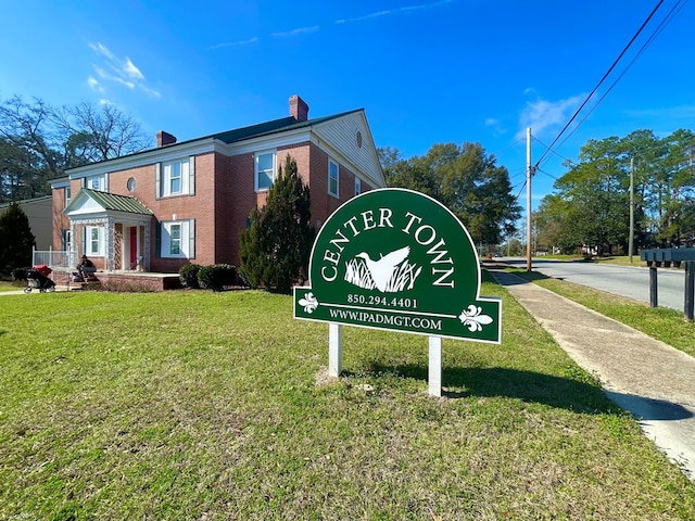 community sign featuring a lawn