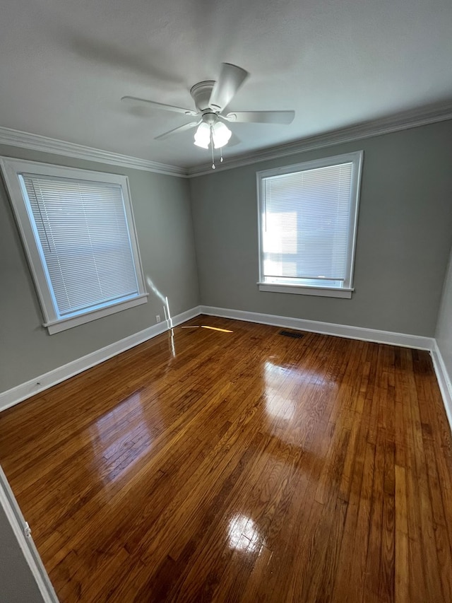 empty room with wood-type flooring, ceiling fan, and crown molding