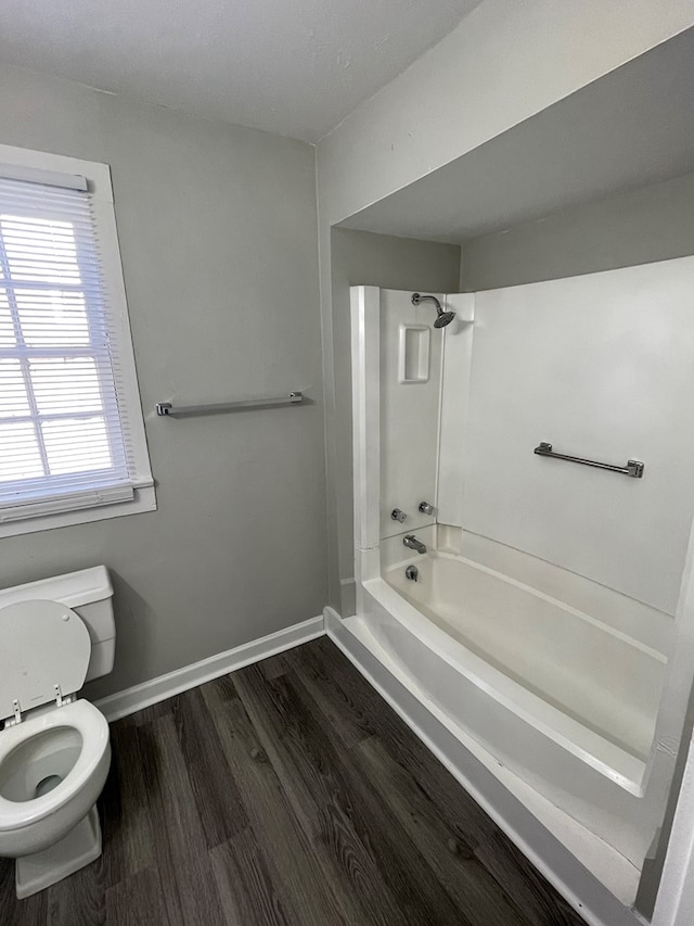 bathroom with shower / tub combination, hardwood / wood-style flooring, and toilet