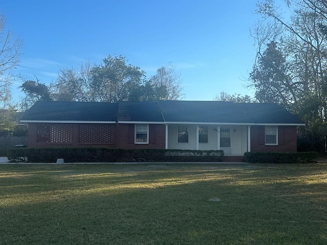 single story home featuring a front lawn and brick siding