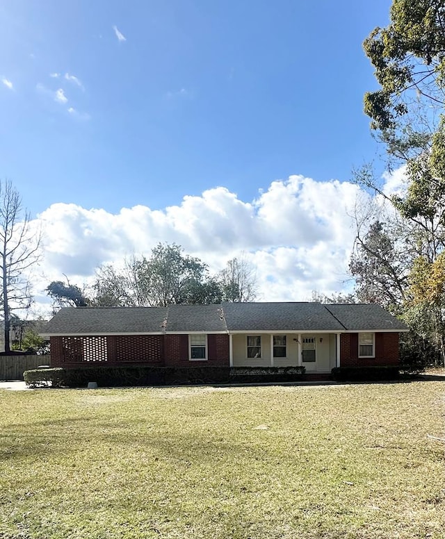 ranch-style house with a front lawn and brick siding