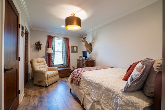 bedroom featuring hardwood / wood-style floors and crown molding