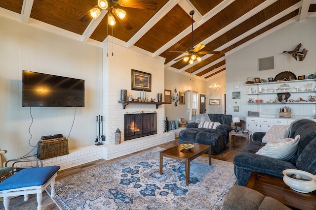 living room with a brick fireplace, wood ceiling, beam ceiling, high vaulted ceiling, and hardwood / wood-style floors