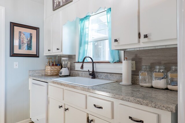 kitchen with white cabinets, white oven, black electric cooktop, and backsplash