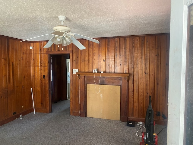 interior space with wooden walls and a textured ceiling