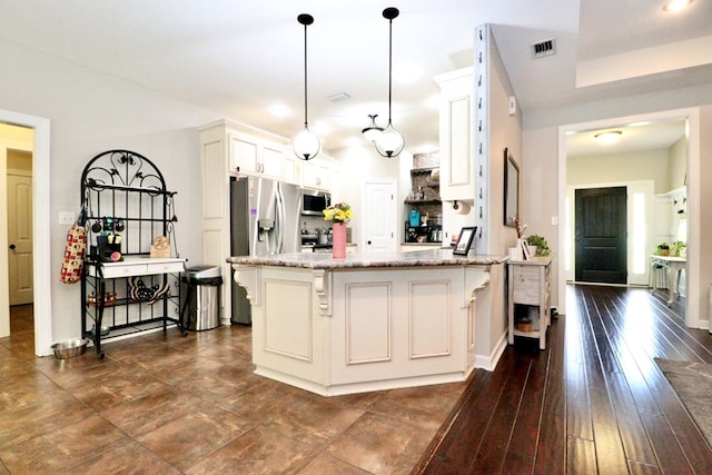 3342 Norton Pl, Valdosta, GA 31605 - kitchen featuring stainless steel appliances, white cabinetry, light stone countertops, pendant lighting, and a kitchen breakfast bar