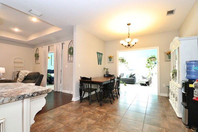 3342 Norton Pl, Valdosta, GA 31605 - dining space with a chandelier and a tray ceiling