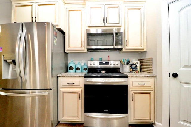 3342 Norton Pl, Valdosta, GA 31605 - kitchen with appliances with stainless steel finishes and cream cabinetry