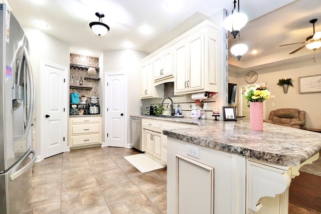 3342 Norton Pl, Valdosta, GA 31605 - kitchen featuring appliances with stainless steel finishes, a peninsula, a ceiling fan, open shelves, and recessed lighting