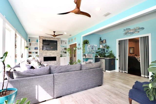 3342 Norton Pl, Valdosta, GA 31605 - living room featuring a ceiling fan, a fireplace, wood finished floors, built in features, and recessed lighting