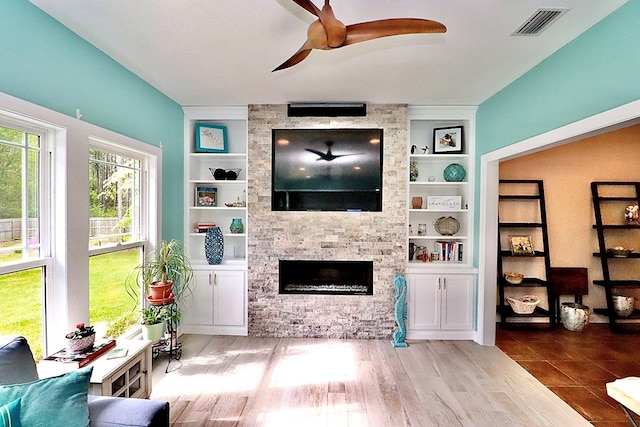 3342 Norton Pl, Valdosta, GA 31605 - living area featuring ceiling fan, a stone fireplace, and built in features