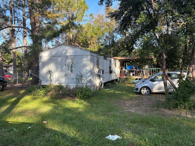 view of property exterior with a yard and cooling unit