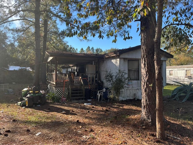 back of property with a porch