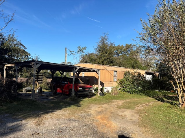 view of parking / parking lot featuring a carport