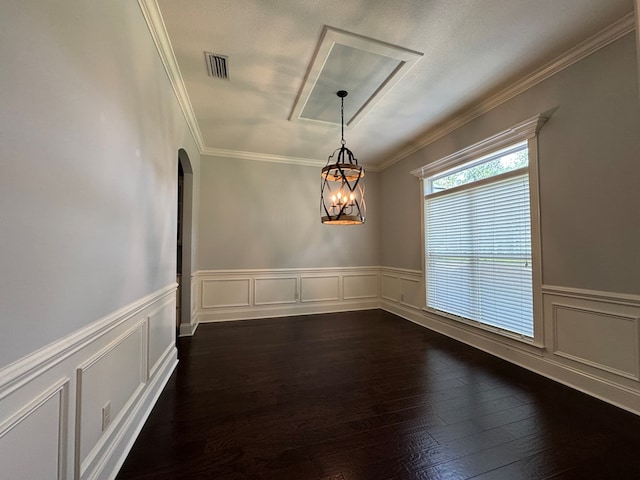 5029 Falling Spgs, Valdosta, GA 31602 - spare room with a chandelier, arched walkways, crown molding, dark wood-style flooring, and wainscoting