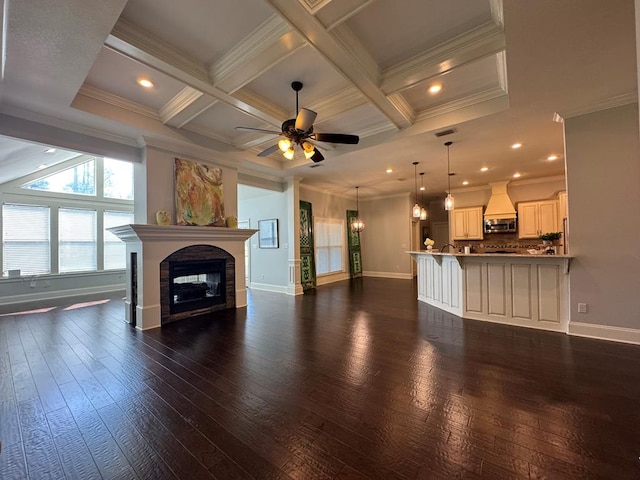 5029 Falling Spgs, Valdosta, GA 31602 - unfurnished living room with ceiling fan, a glass covered fireplace, ornamental molding, dark wood-style flooring, and beamed ceiling