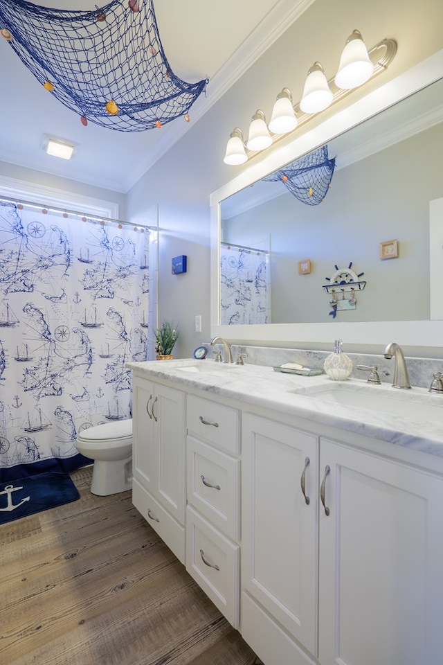 bathroom featuring hardwood / wood-style floors, vanity, ornamental molding, curtained shower, and toilet