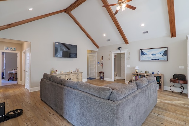 living room with beamed ceiling, ceiling fan, high vaulted ceiling, and light hardwood / wood-style flooring