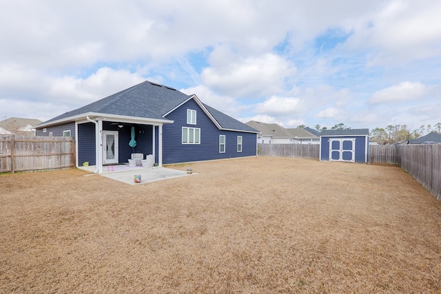 back of house with a patio and a storage shed