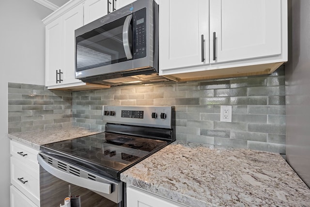 4848 Lori St, Valdosta, GA 31605 - kitchen featuring stainless steel appliances, light stone counters, backsplash, and white cabinetry