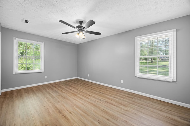 4848 Lori St, Valdosta, GA 31605 - unfurnished room with light wood finished floors, baseboards, ceiling fan, and a textured ceiling