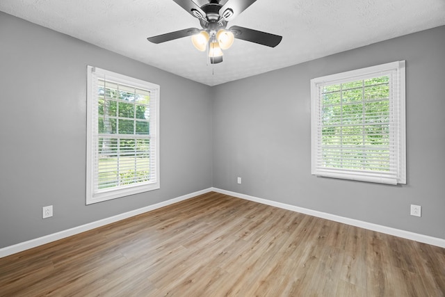 4848 Lori St, Valdosta, GA 31605 - spare room featuring plenty of natural light, baseboards, wood finished floors, and a textured ceiling