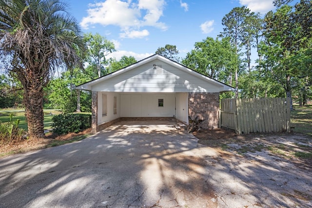 4848 Lori St, Valdosta, GA 31605 - view of front of house with brick siding, fence, driveway, and an attached carport