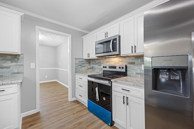4848 Lori St, Valdosta, GA 31605 - kitchen with stainless steel appliances, baseboards, light wood-type flooring, white cabinetry, and ornamental molding