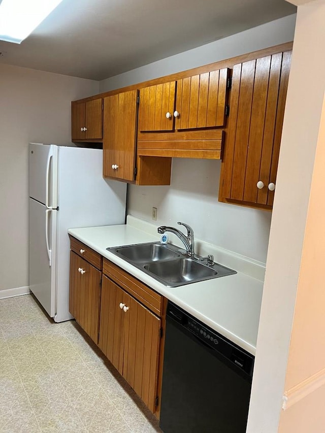 kitchen featuring white fridge, sink, and black dishwasher