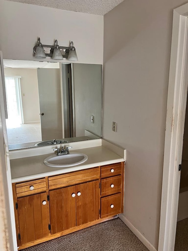 bathroom featuring vanity and a textured ceiling