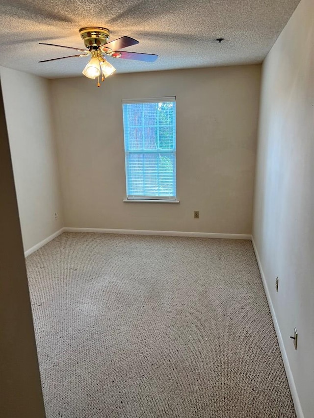 spare room with carpet flooring, ceiling fan, and a textured ceiling